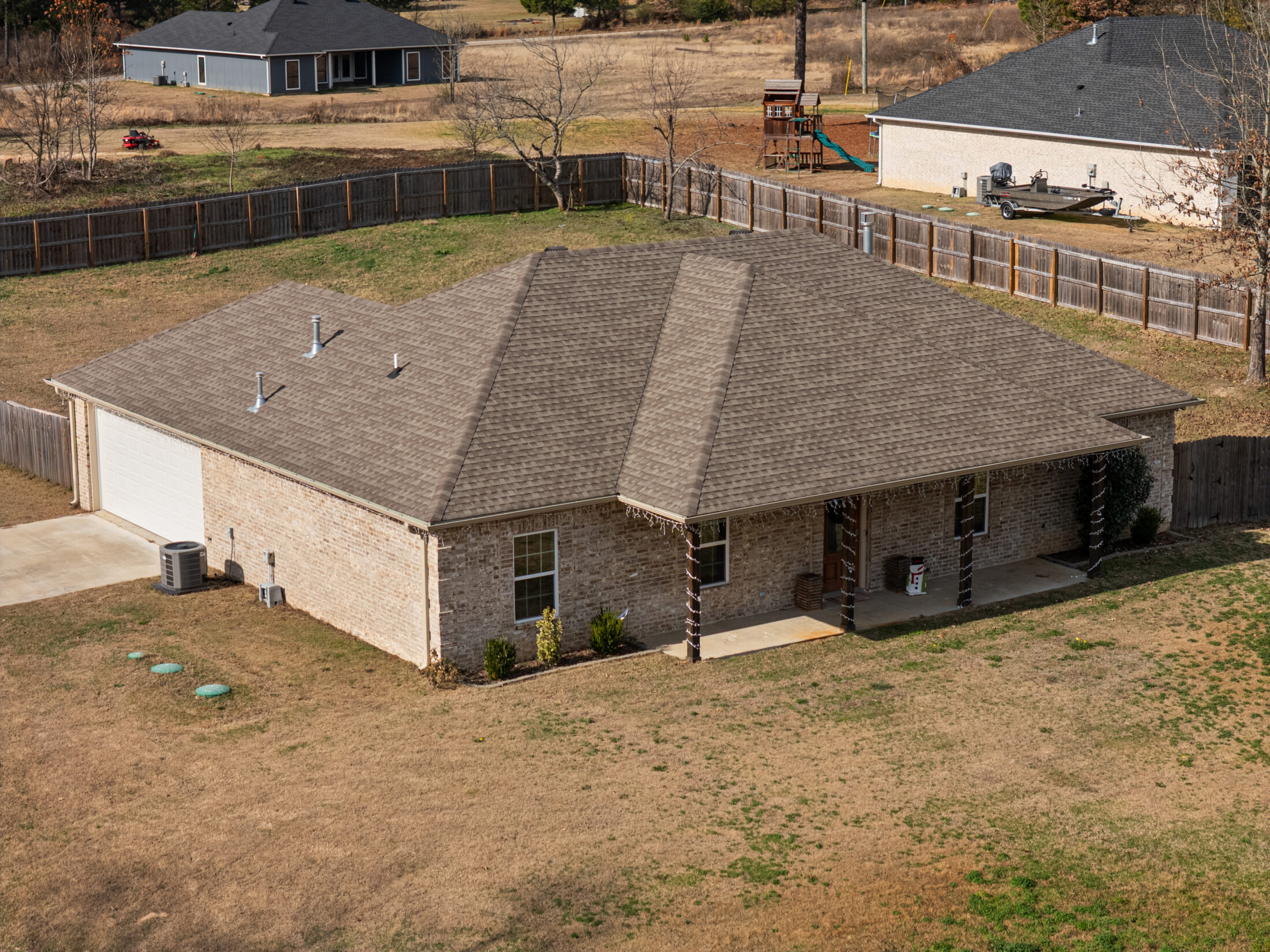 a brick house with vinyl siding with a covered front porch and an attached garage