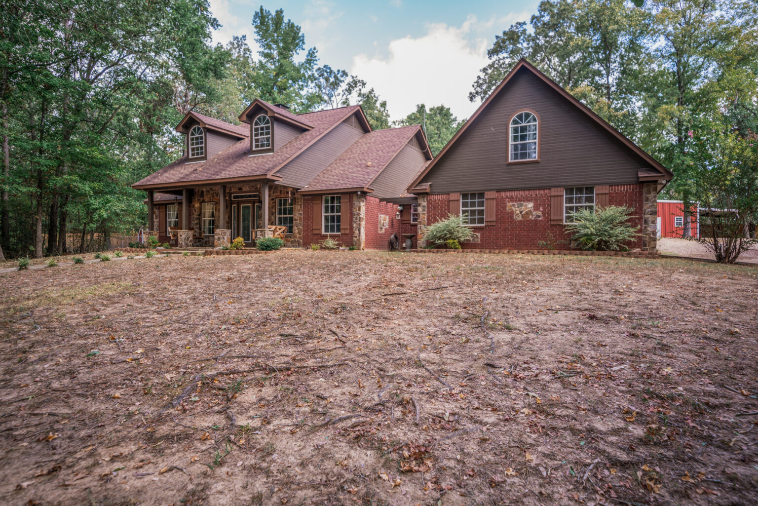 a house features a mix of red brick and stone veneer on the exterior