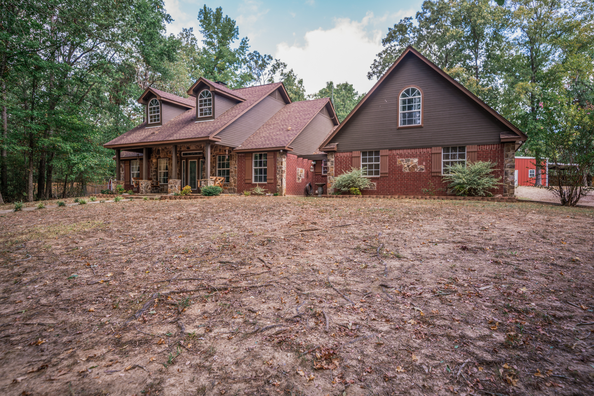 a house features a mix of red brick and stone veneer on the exterior