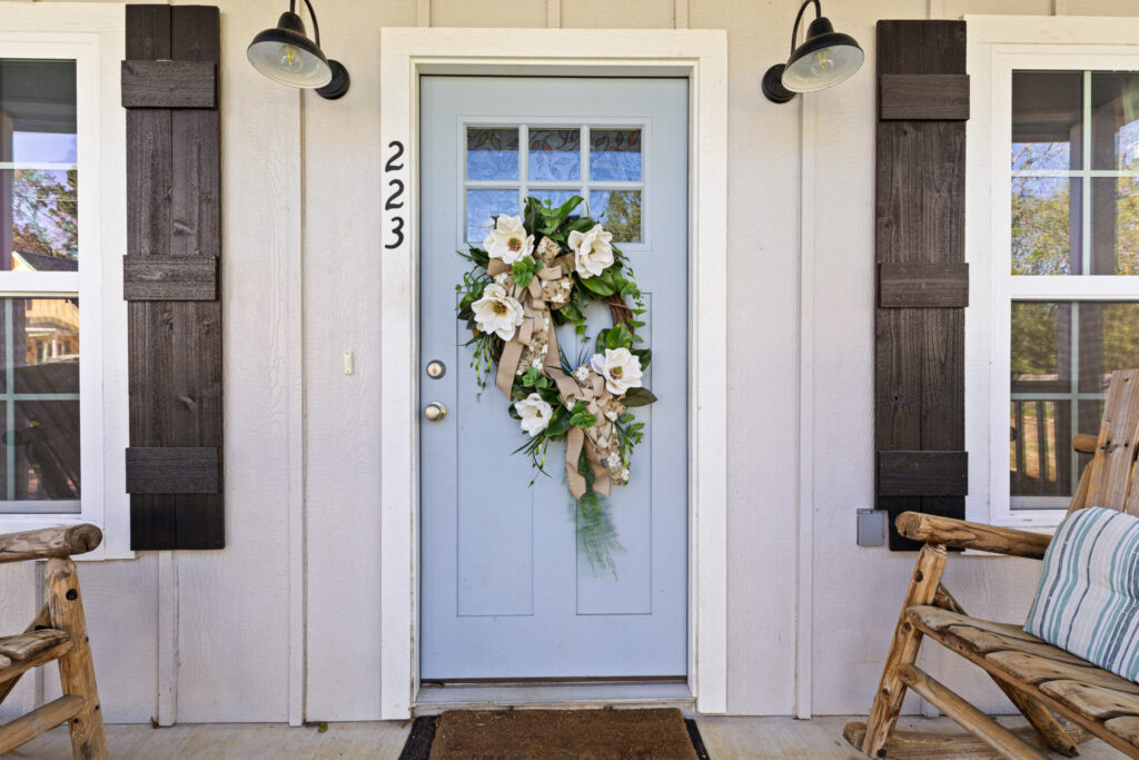 light blue color door features a decorative floral wreath