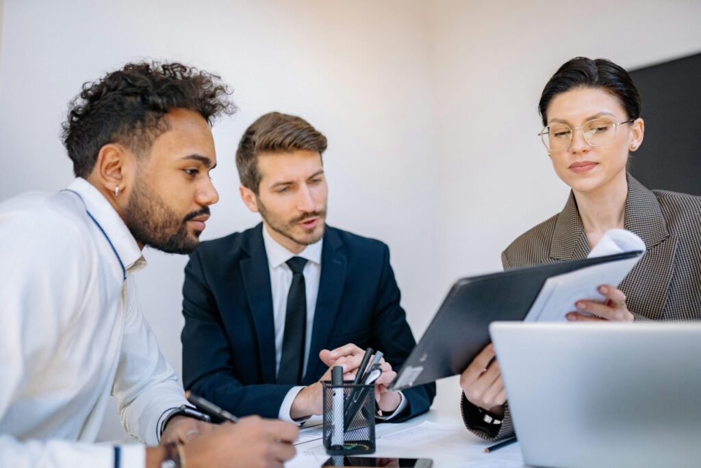 coworkers looking at a document in a meeting