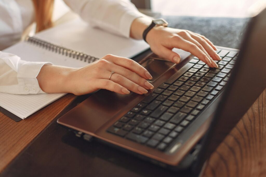 a person using a black laptop on a table
